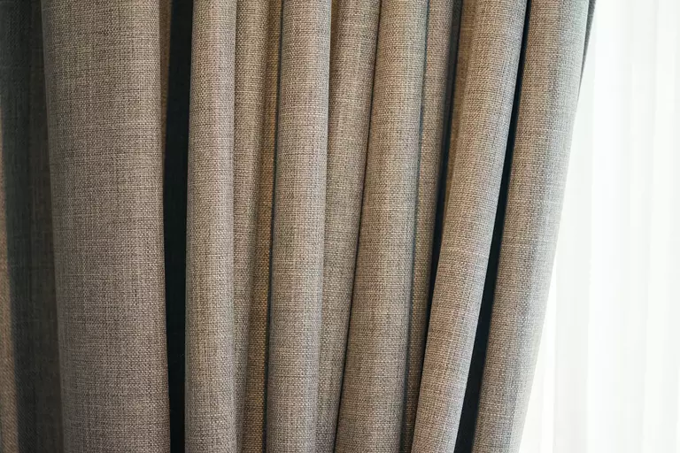 Close-up of curtains on windows of a home.