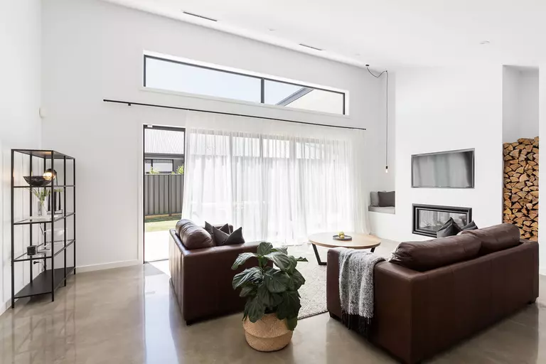 Light-filtering curtains on sliding patio doors in a living room that allow natural light to shine in and brighten up the room.