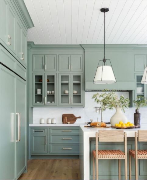 Green cabinets in a large kitchen