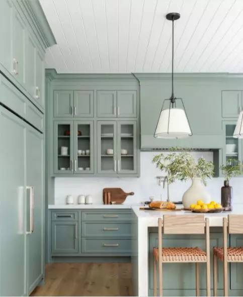 Green cabinets in a large kitchen