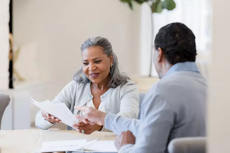 A woman and a man looking at papers.