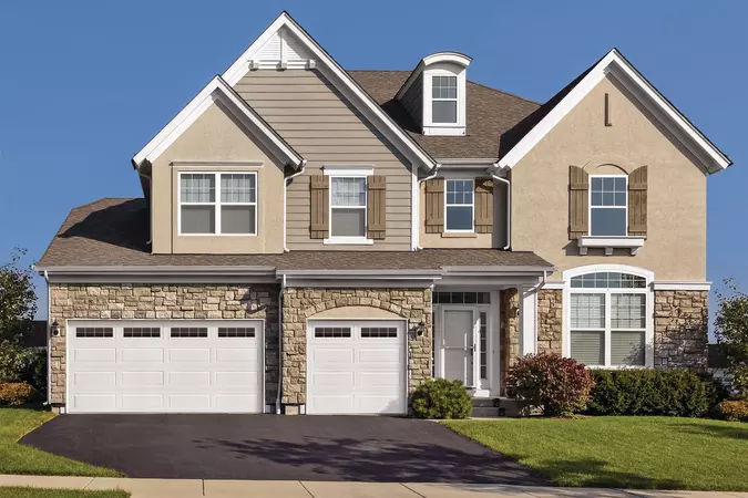 White Ranch Panel residential garage door with Stockton windows
