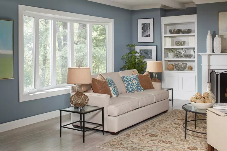 Living room with a white five-pane bow window.