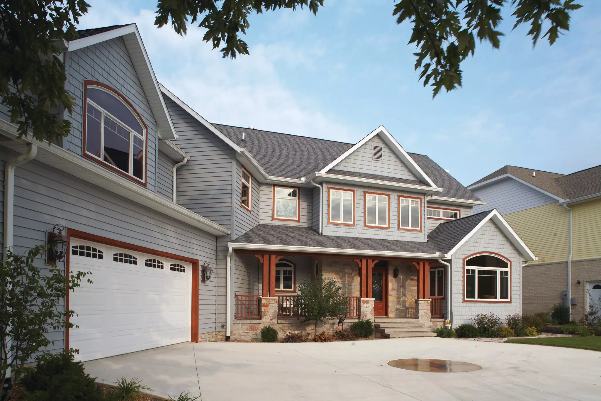 Exterior of a house with various window shapes and window trends
