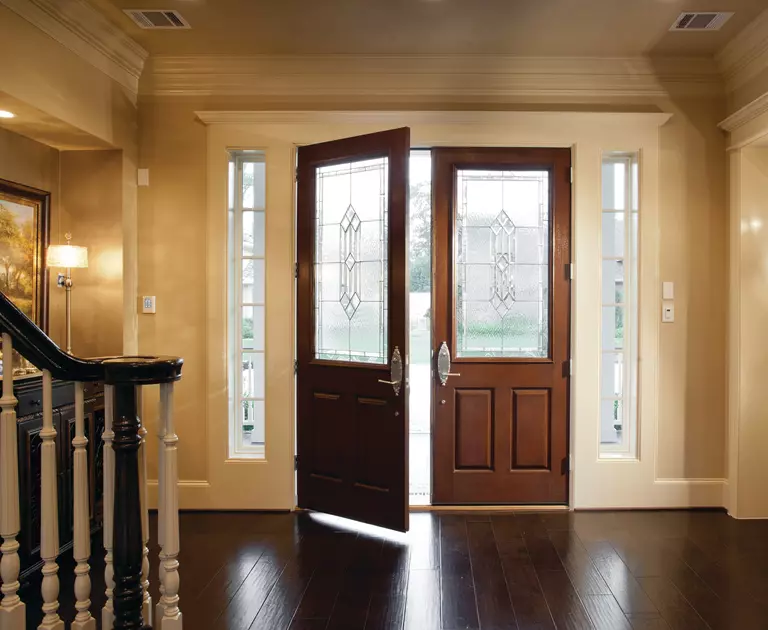 Double entry front doors with a pair of white sidelites.
