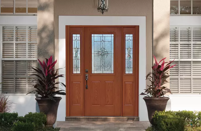 2 panel 1/2 lite woodgrain entry door with matching 1/2 sidelites in an oak grain with laurel glass 
