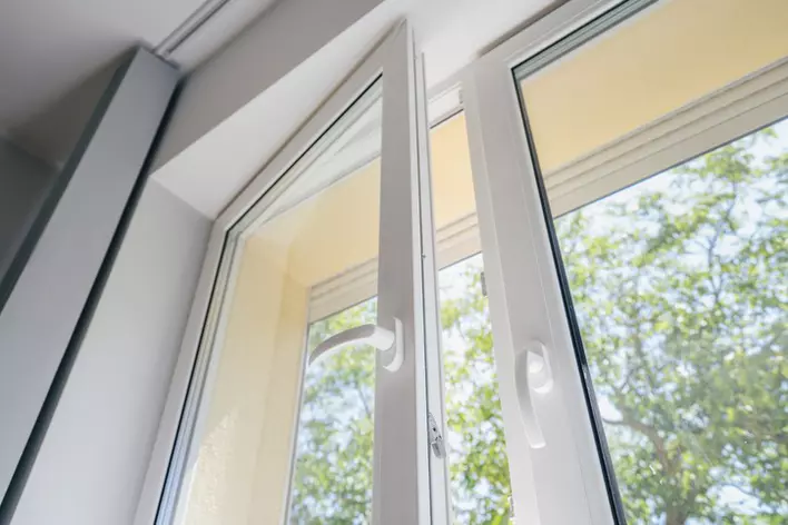Open energy-efficient window in a home providing ventilation for mold prevention.