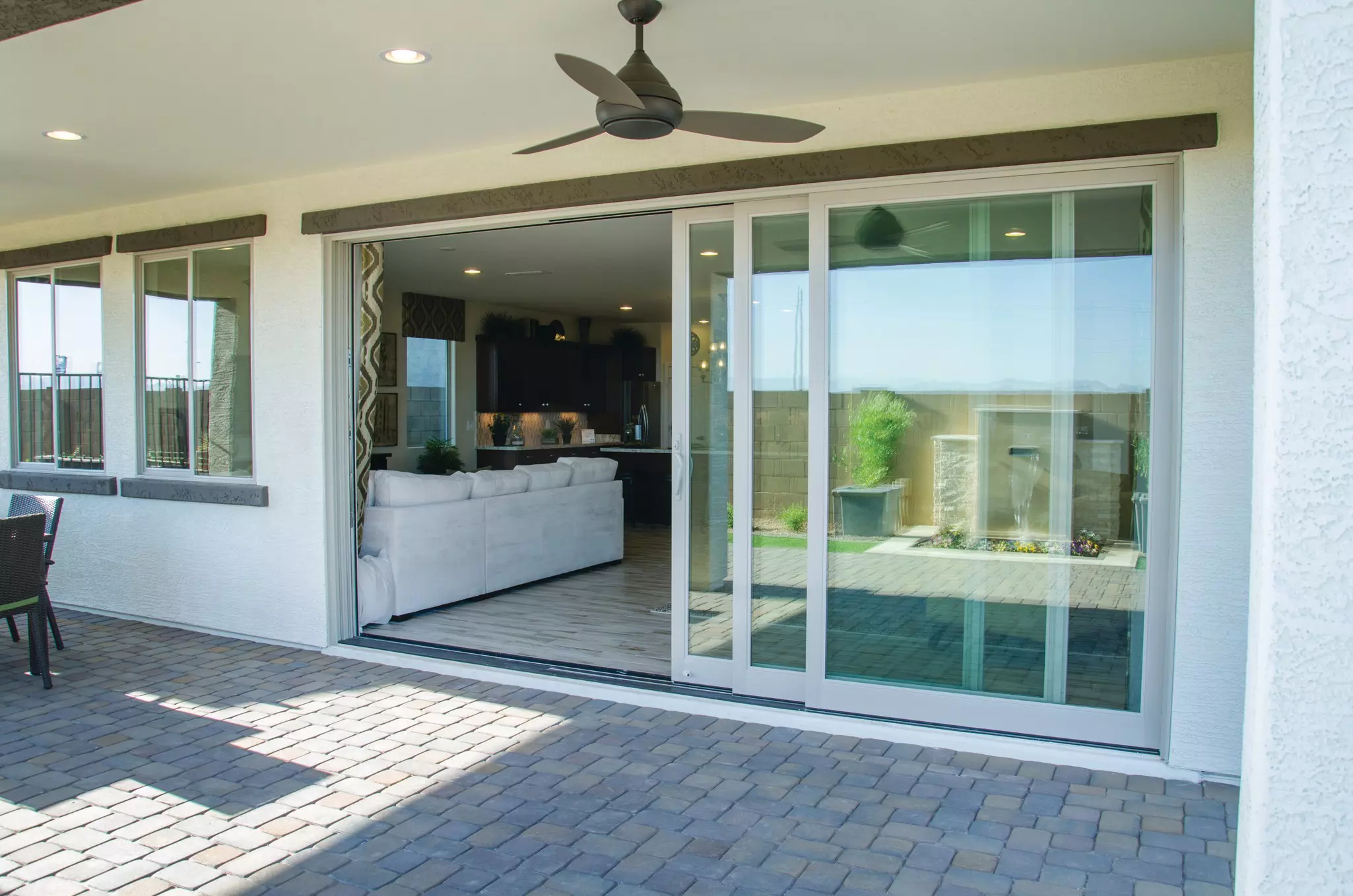 House exterior with sliding patio doors open, showing the inside of the home.