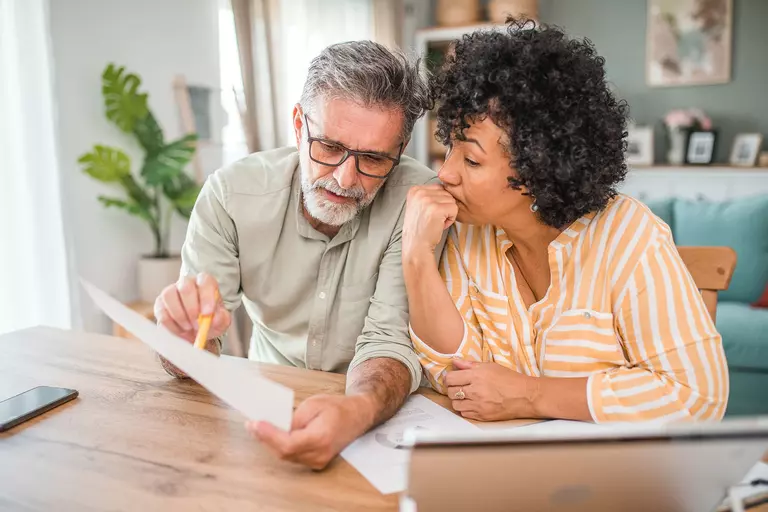 A couple reviewing financial documents.
