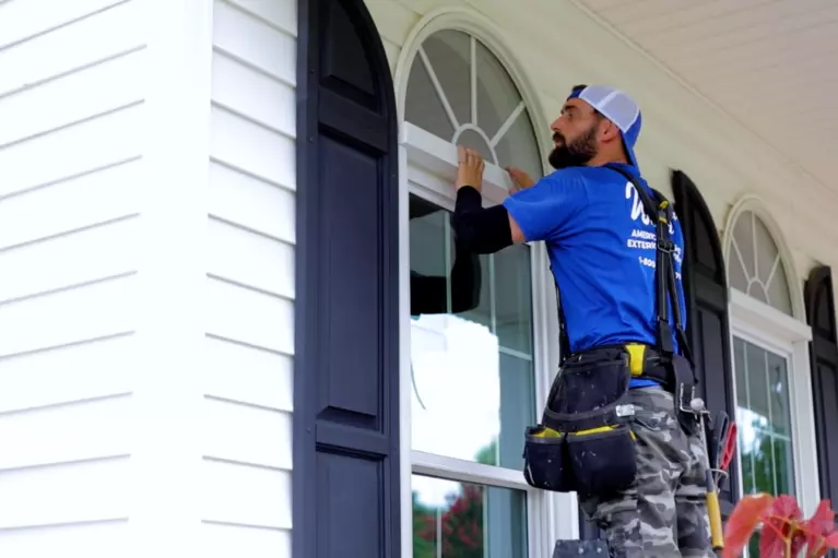 A Window World professional inspects a completed replacement window installation.