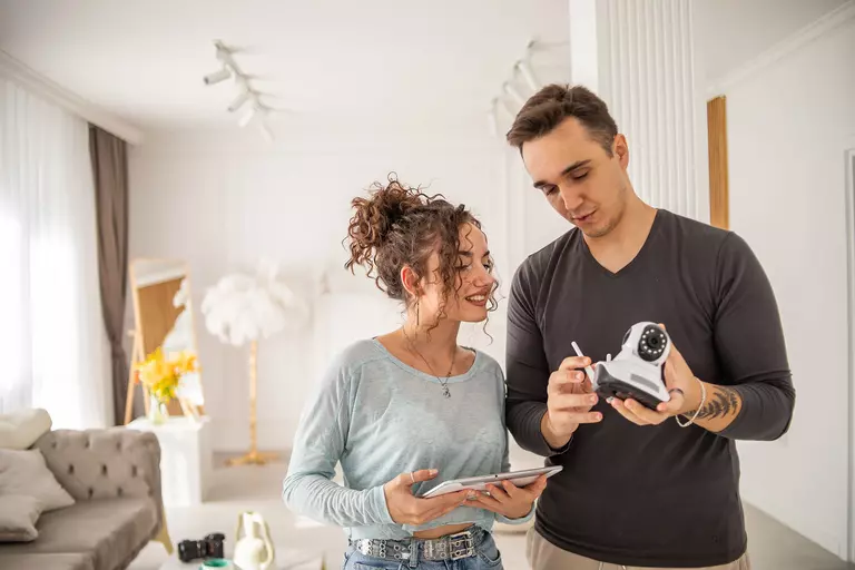 Couple looking at a home security system in an effort to increase privacy.