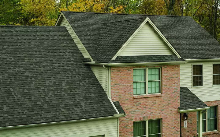 2 story home with brick and vinyl siding with Owens Corning's Oakridge shingle line in the color Driftwood