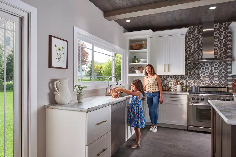 Mother and daughter in kitchen in front of Window World windows