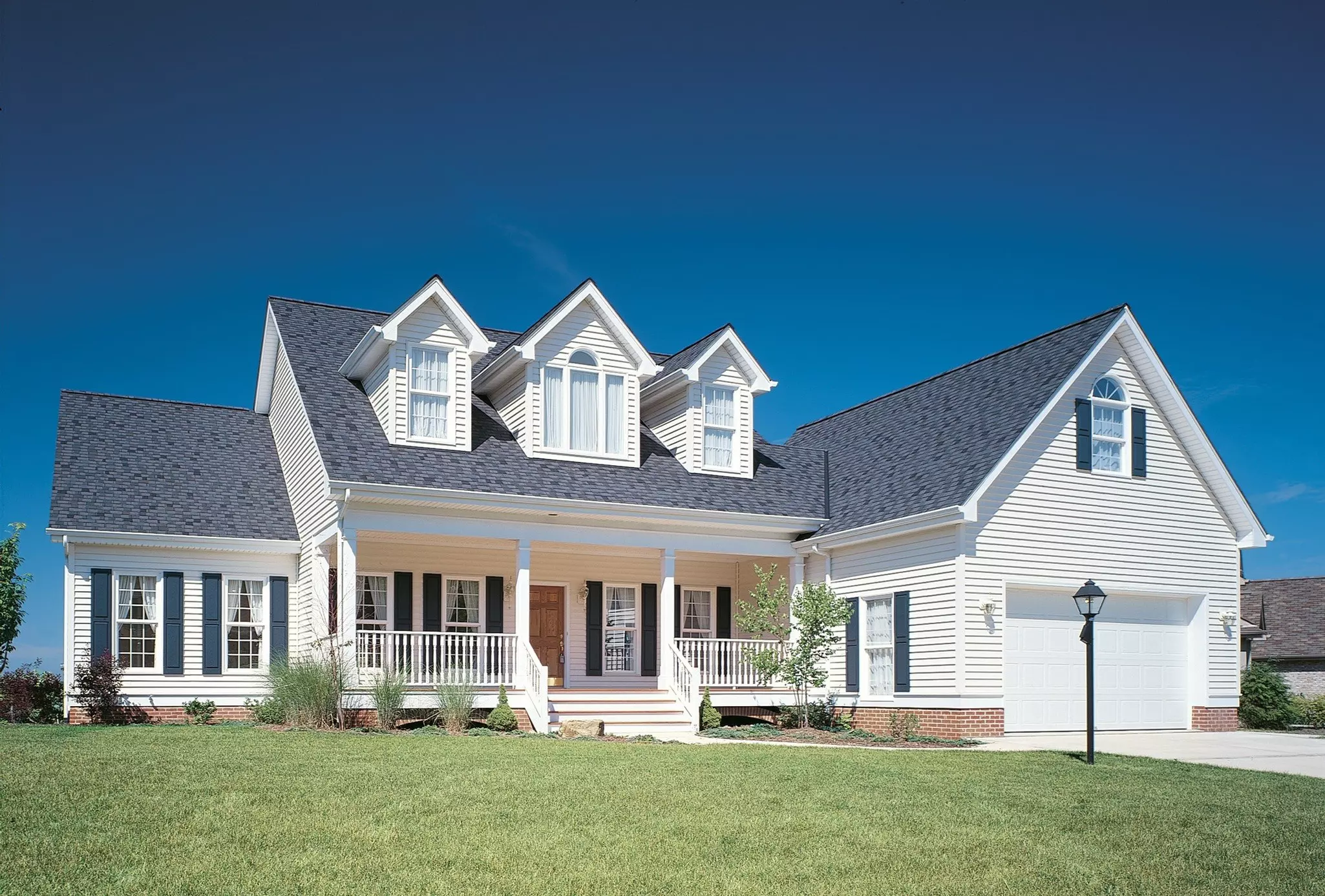 Front yard of a two-story home with white siding.
