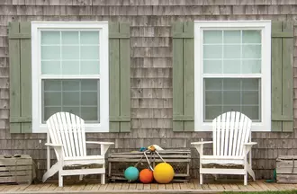 Impact-resistant double-hung window featuring sleek white vinyl frame and reinforced laminated glass.