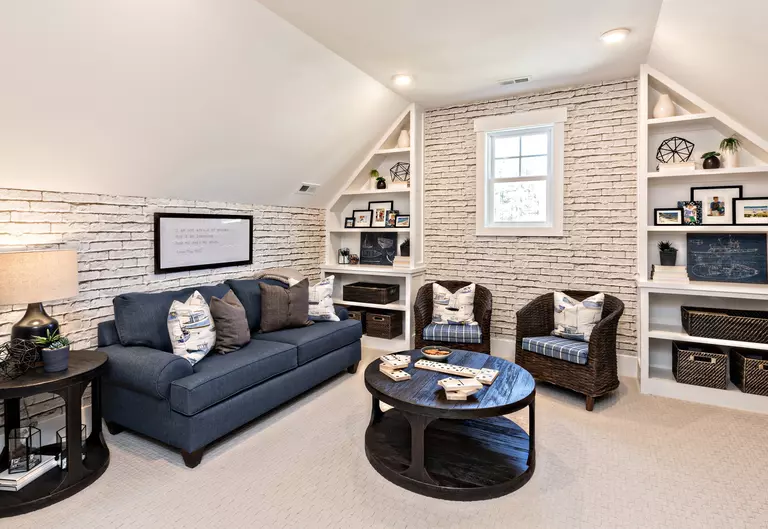 A living room with brick walls and a small, energy-efficient window.