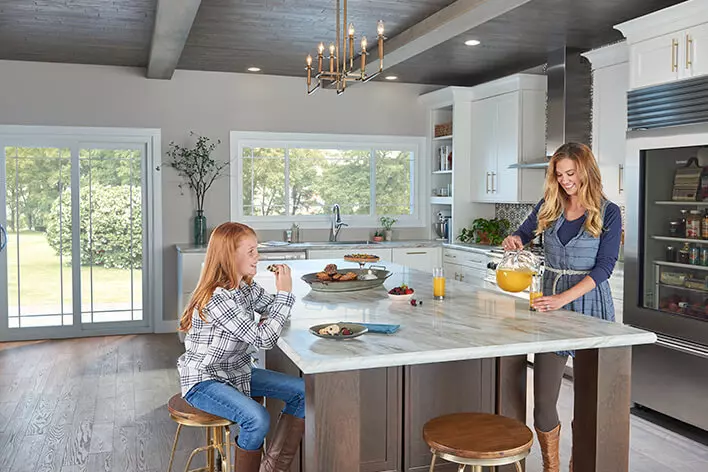 Mom and daughter sharing breakfast in a well-lit kitchen