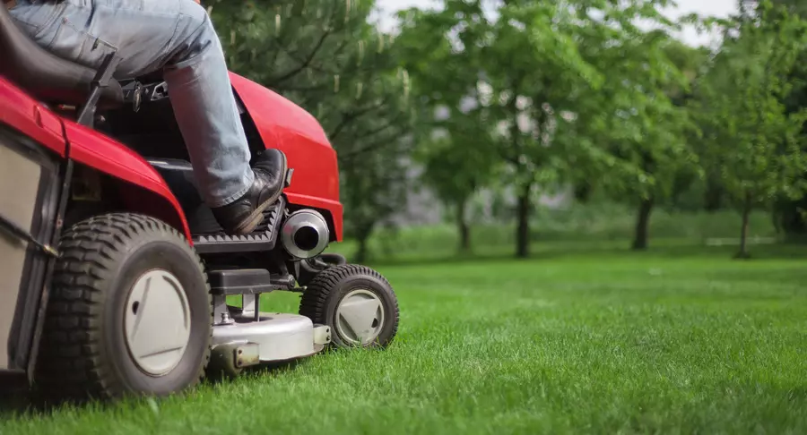 Person riding a lawn mower 