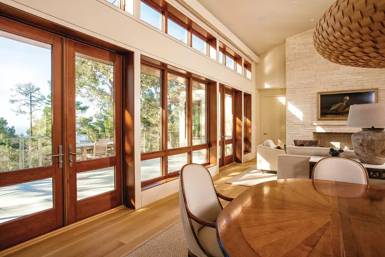 A living room with two sets of hinged wood-clad patio doors.