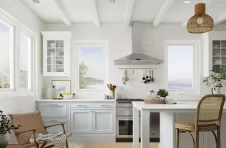 Casement windows in a spacious kitchen with the ocean in the background of the windows