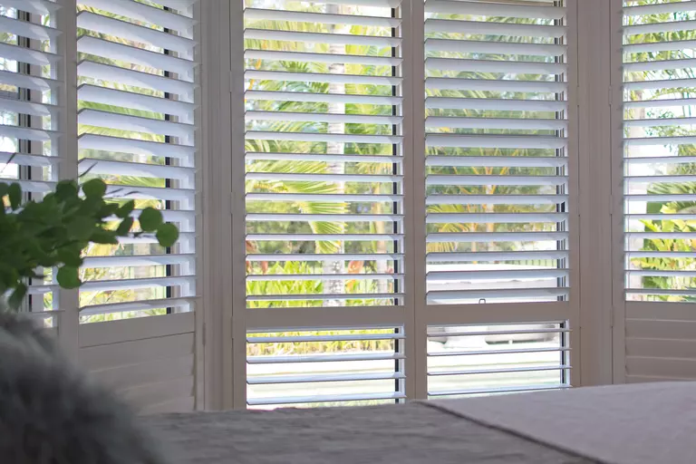 Shutters on patio doors that enhance privacy but allow natural light to brighten the room.
