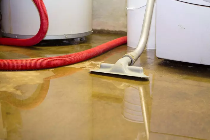 Cleaning a flooded basement as part of mold prevention efforts.