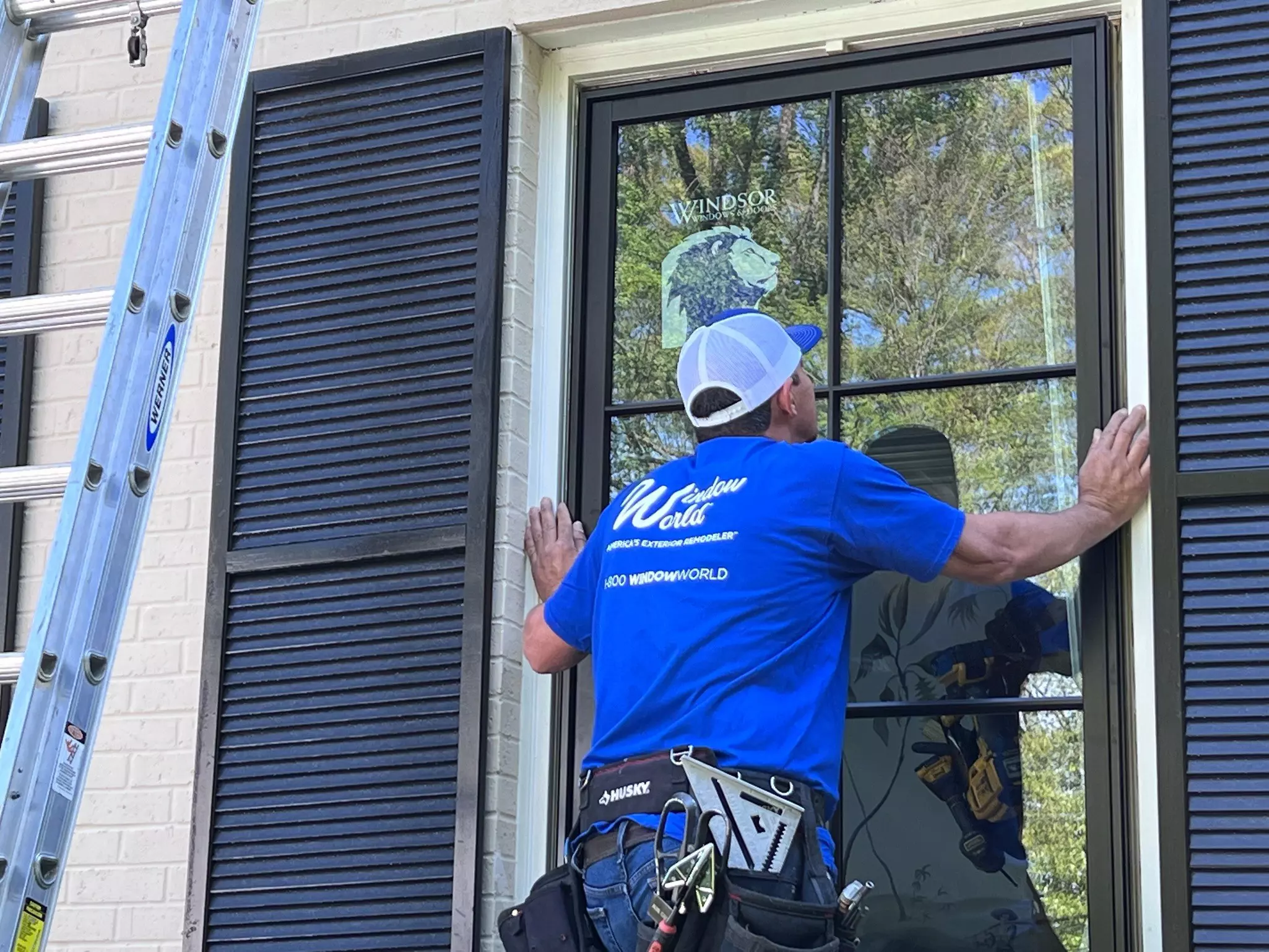 Window World installation worker installing a new window.