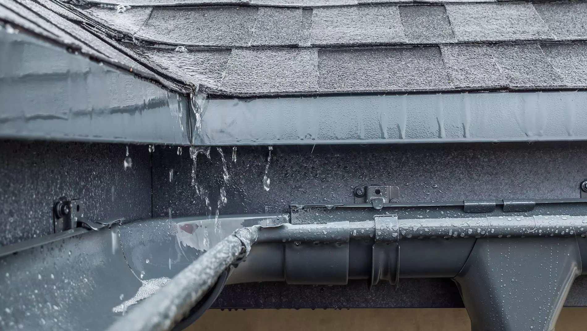 Steel gray outdoor gutters on a house