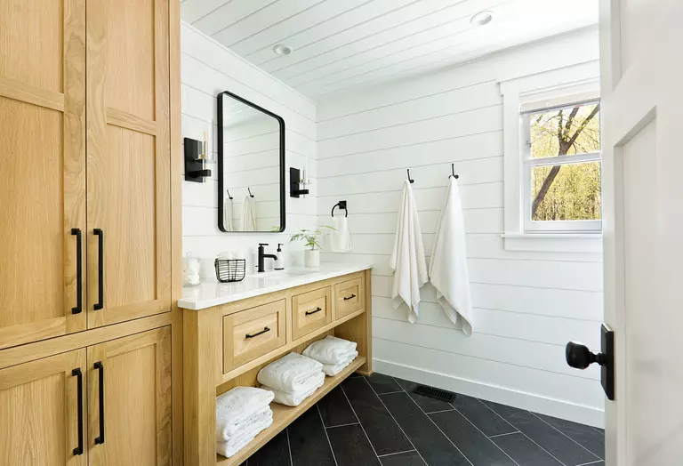 Interior of a white bathroom showcasing the vanity and bathroom window.