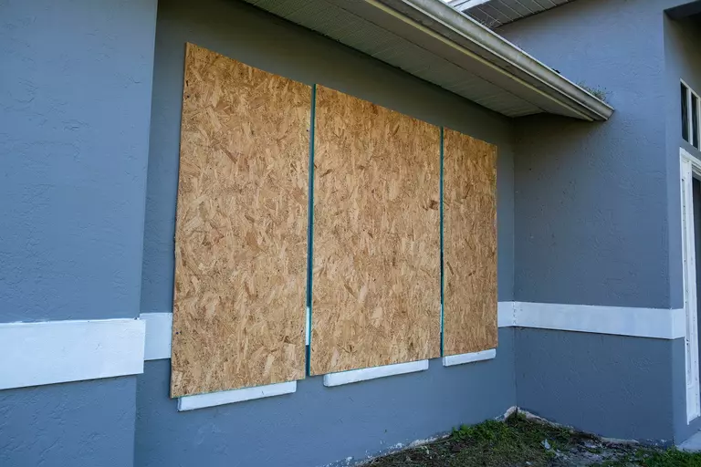 Home windows boarded up for hurricane protection.