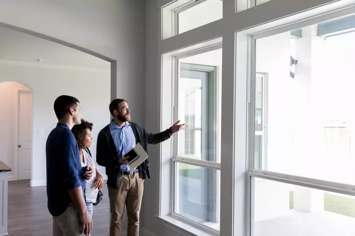 A contractor walks a couple through their home and points out ways Low-E windows could help with their power bill and home resale value.
