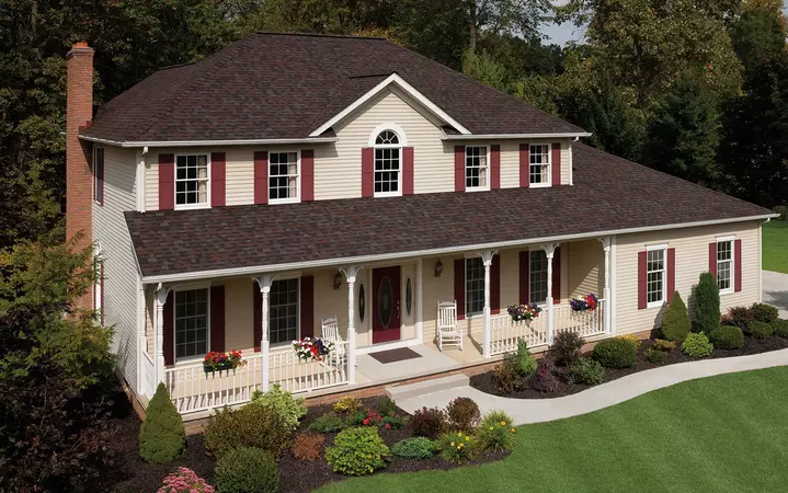 2 story home with cream colored vinyl siding with Owens Corning's TruDefinition Duration Design shingle line in the color Merlot.