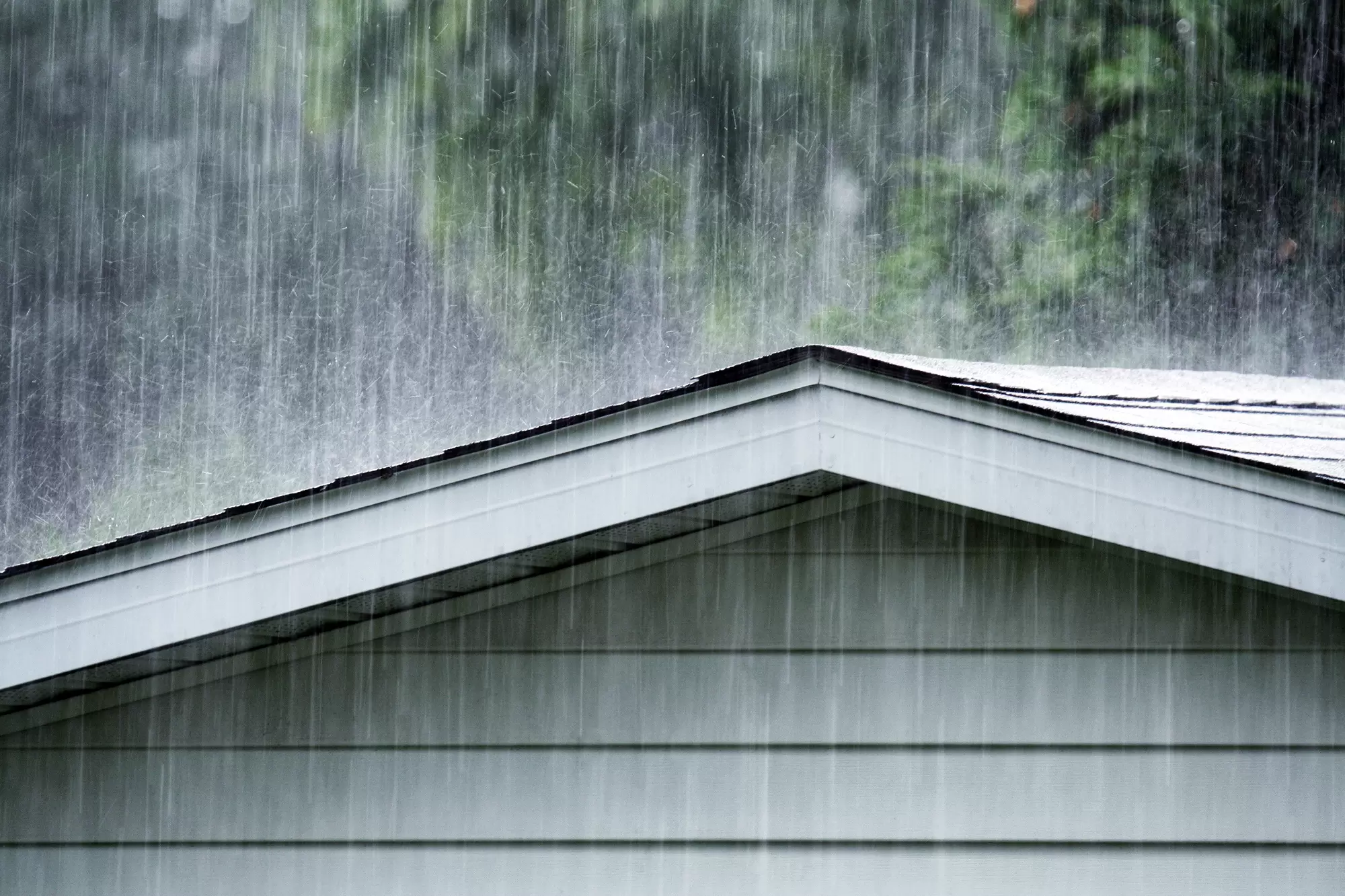 Roofline of a home in heavy rain.