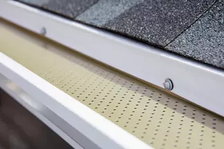 Close-up of the T-Rex Continuous Hanger Gutter System on a home