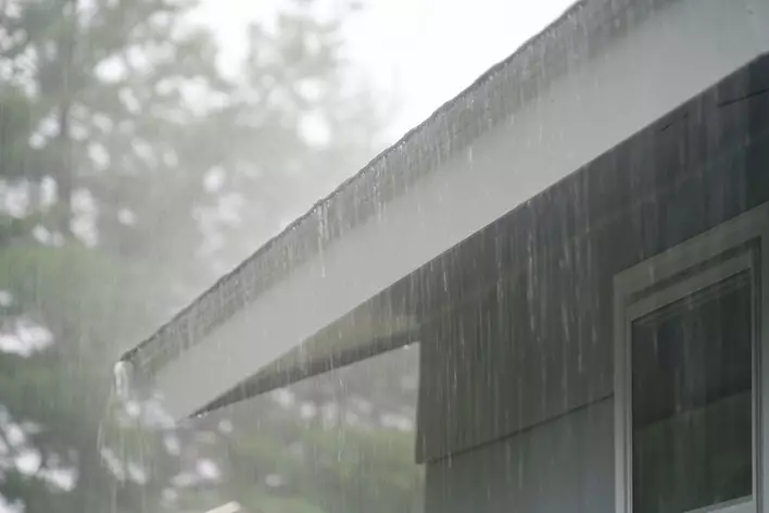 Heavy rain on the roof of a house