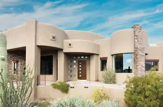Stucco home with a woodgrain entry door