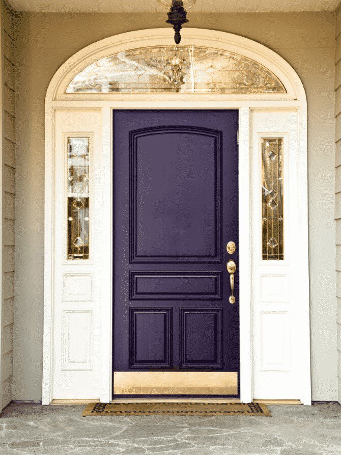 Purple front door on an ornate porch