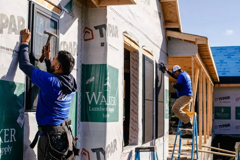 Window World installers fitting windows into a new home.