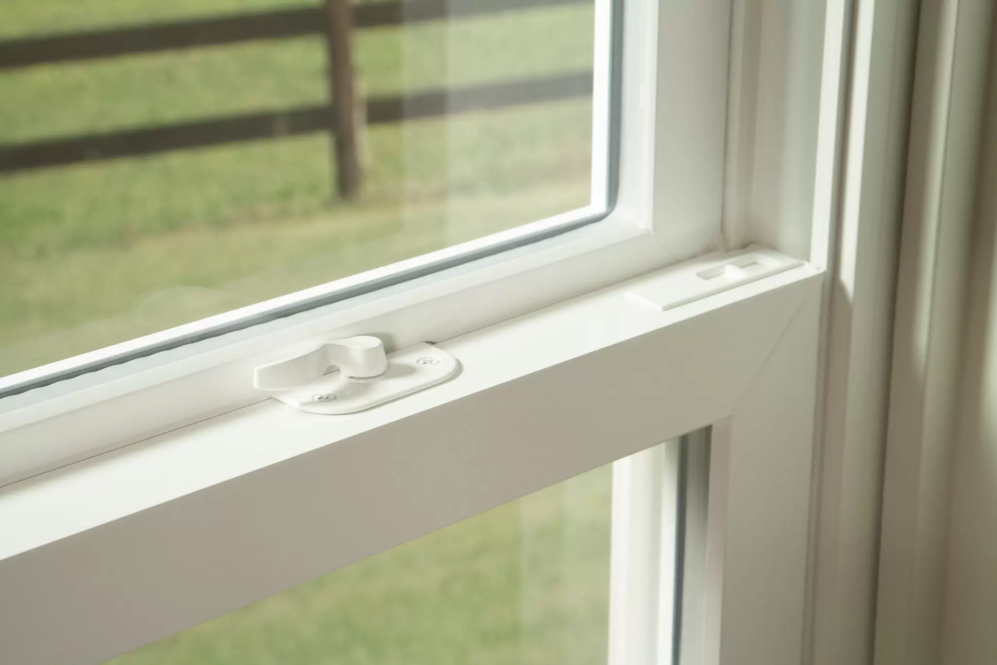 Close-up of a white window frame with lock.