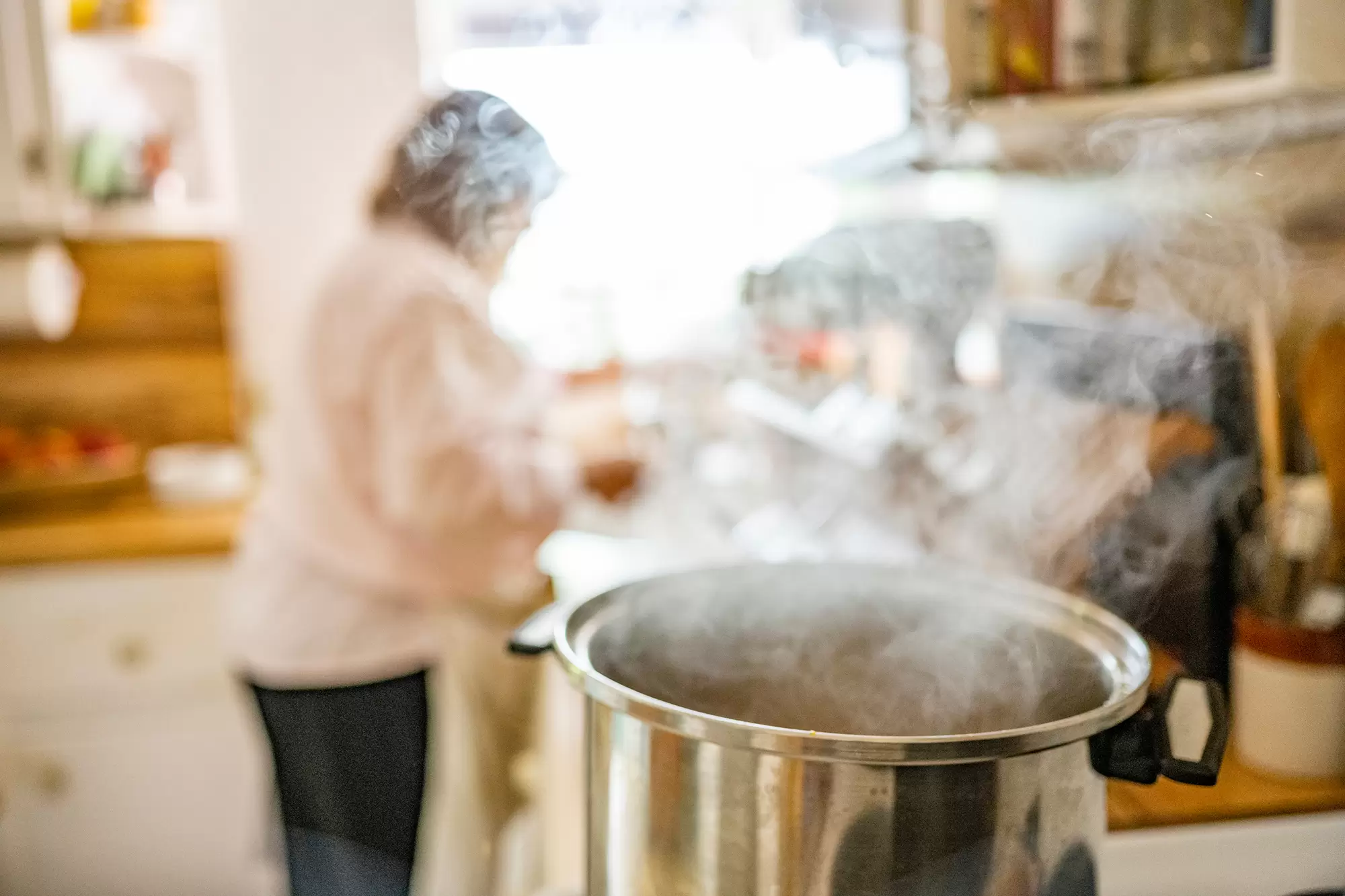 Close-up of a cooking pot with thick steam.