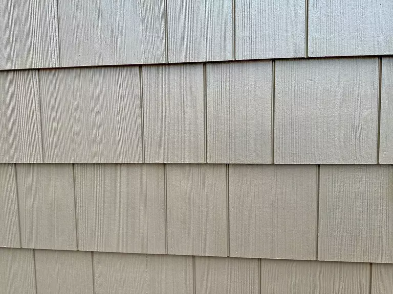 Closeup of gray fiber cement siding panels.