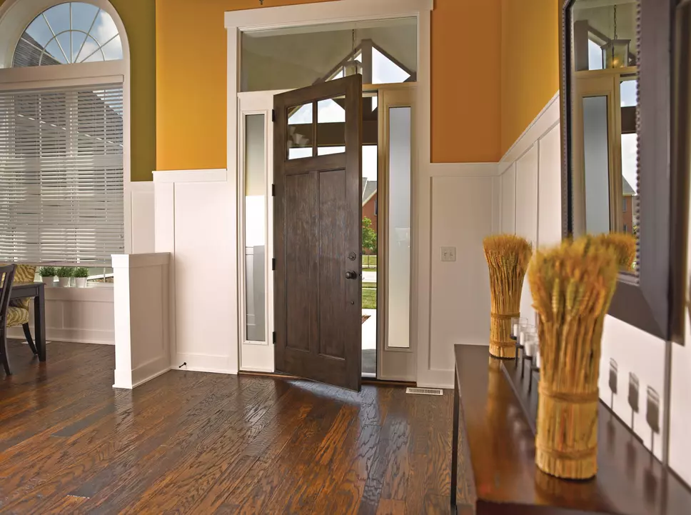 An open woodgrain entry door from inside a living area