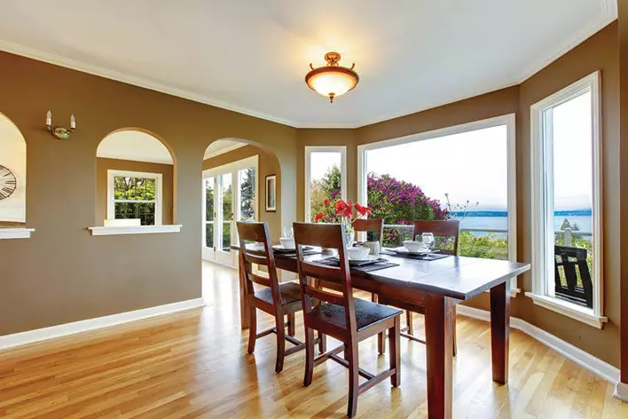 Dining area in a beach house with picture windows facing the beach