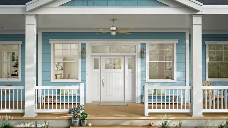 Blue house exterior featuring coastal windows and doors.