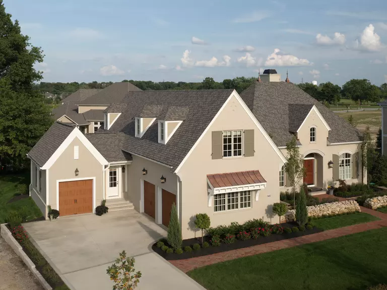 Aerial view of a two-story home with a beige exterior.