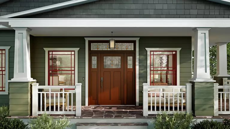 Newly renovated exterior of a home with green siding.