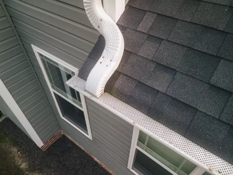 Downward angle of gutter guard system on a home atop the roof.