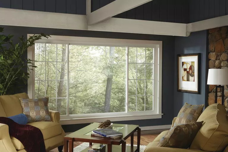 Living room of a home with an array of sliding windows and a picture window.