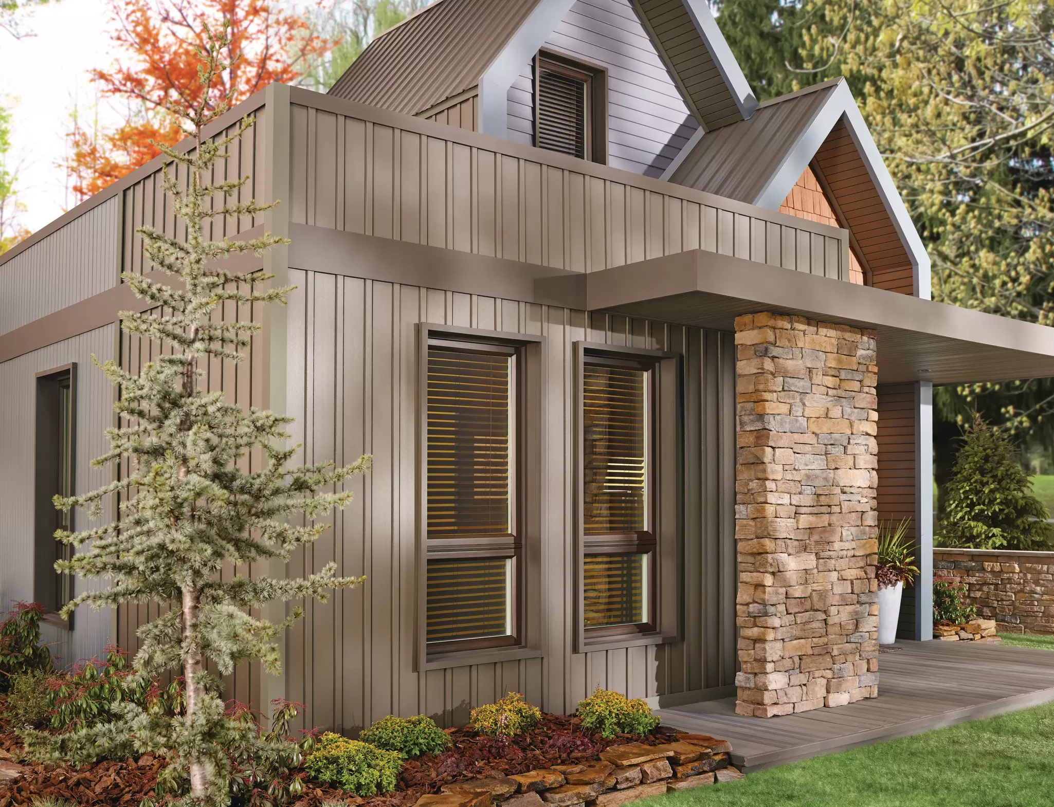 Modern home exterior with vertical siding, stone columns, and landscaped front yard.