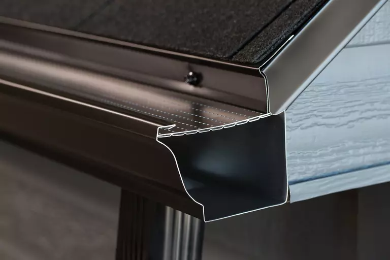 Closeup of a metal gutter guard with two filtering layers.